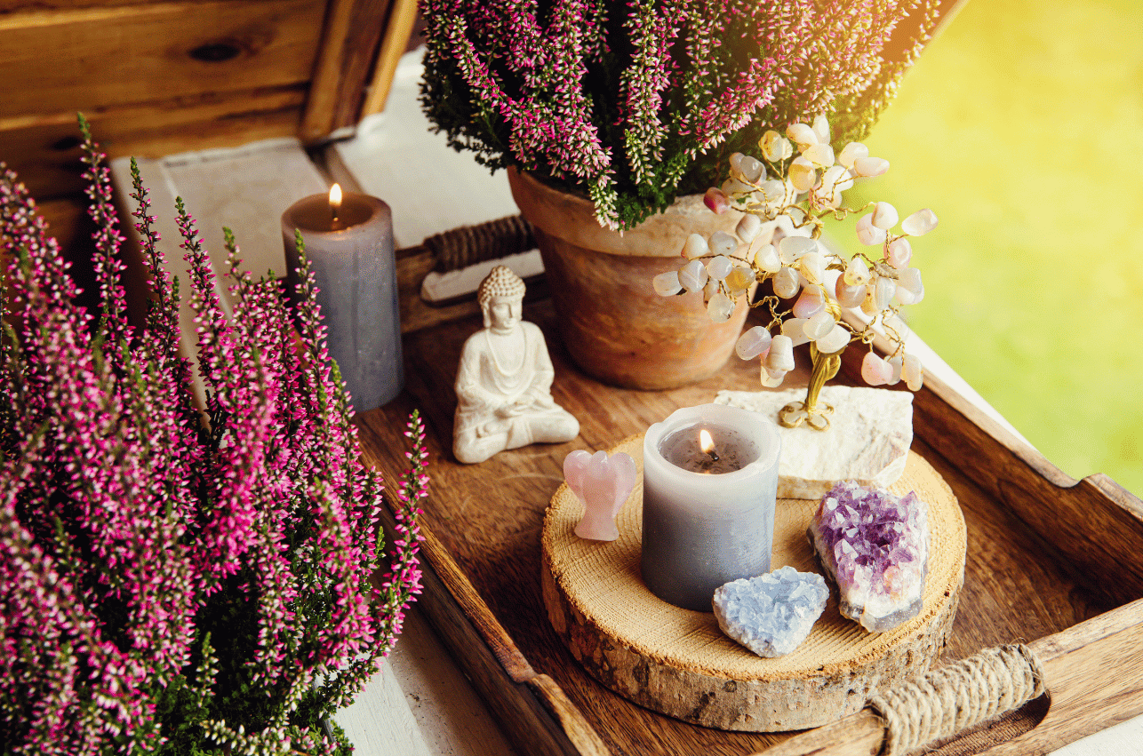 A candle and some flowers on a wooden table
